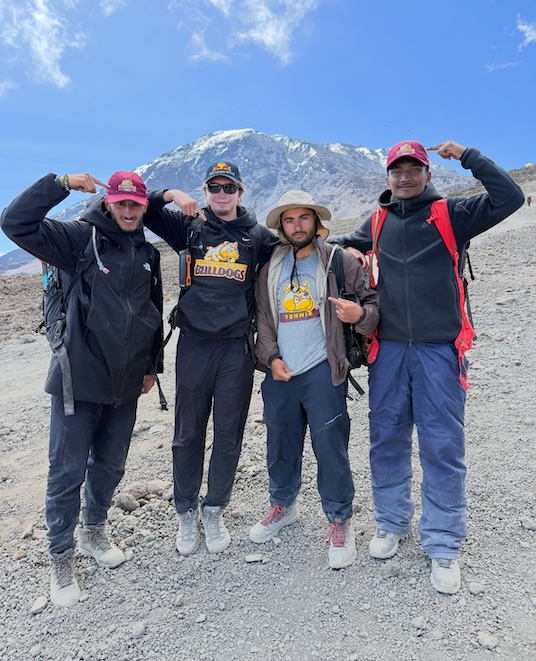 (Left to right) Aymen Kuc, Ryan Badre-Hume, Allen Mardakhayev, and Mujibur Rahman Shaad show off their Bulldog pride on Mt. Kilamanjaro. 