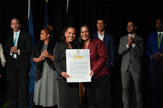 Deputy Mayor Ana J. Almanzar (left) presents María E. Pérez y González, Professor with the Citation of Honor.