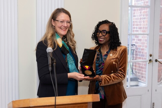 Michelle J. Anderson presents the Presidential Medal of Honor to Congresswoman Yvette Clarke.
