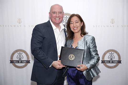 Beatrice Long (right) with the President of Steinway USA, Gavin English. 