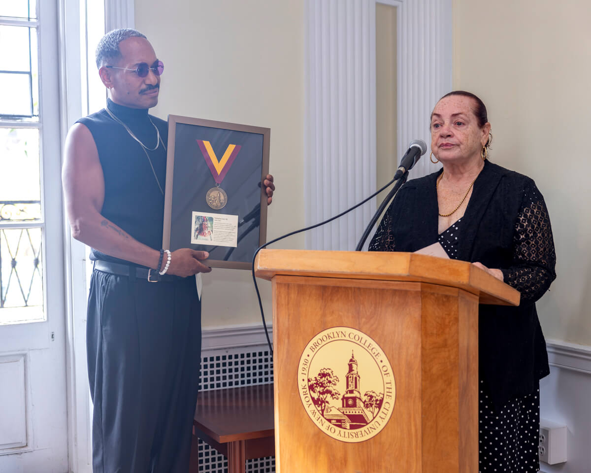 (Left to right) Brooklyn College student and chosen son of the late Victoria Cruz, Carlos Alberto Villacres, listens as Cruz’s sister, Heydey Cruz, reflects on the pioneering advocate’s enduring legacy and profound impact on LGBTQ+ and transgender communities.