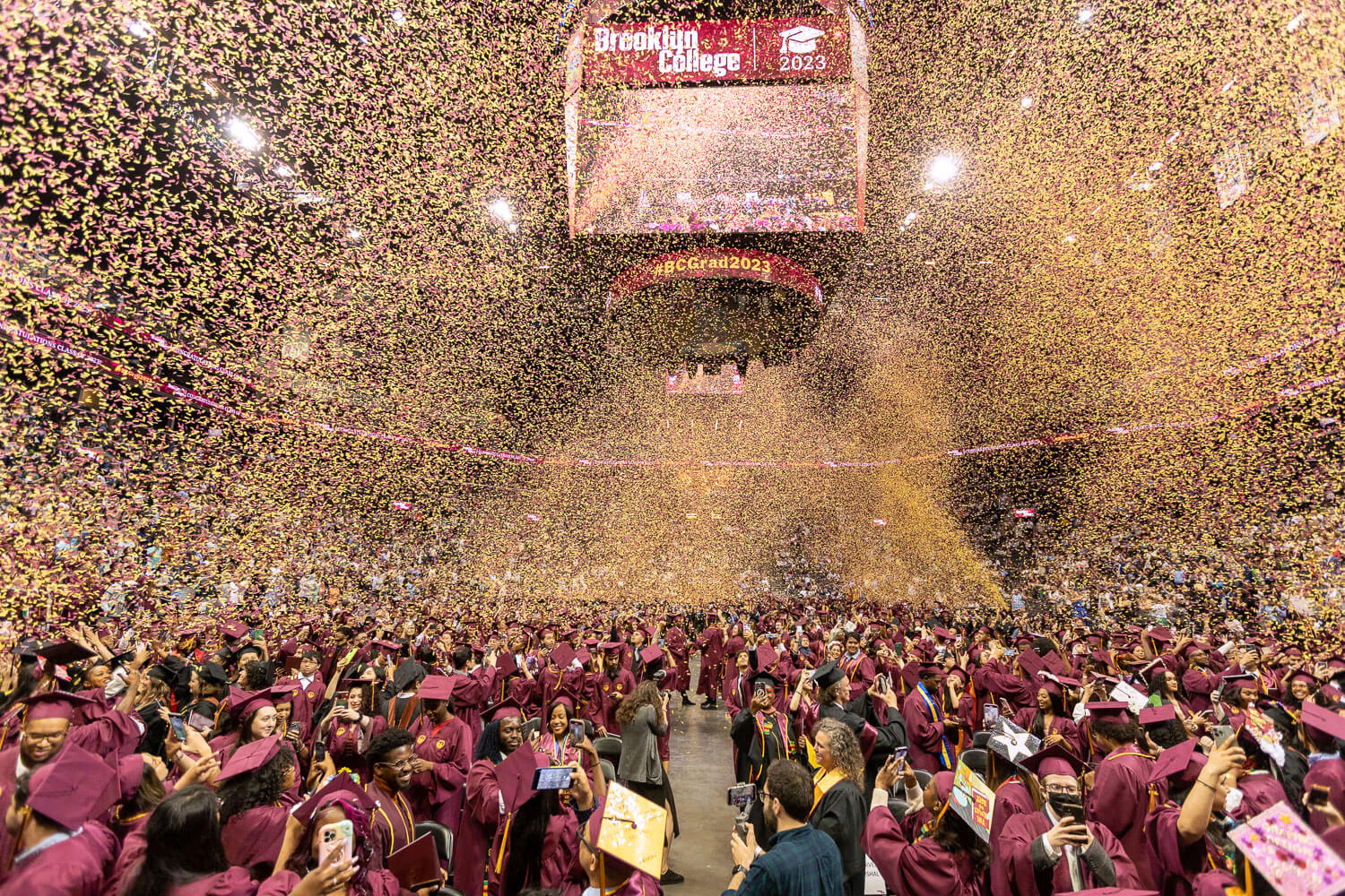 The confetti flies and graduates celebrate the 2023 Brooklyn College Commencement at Barclays Center.