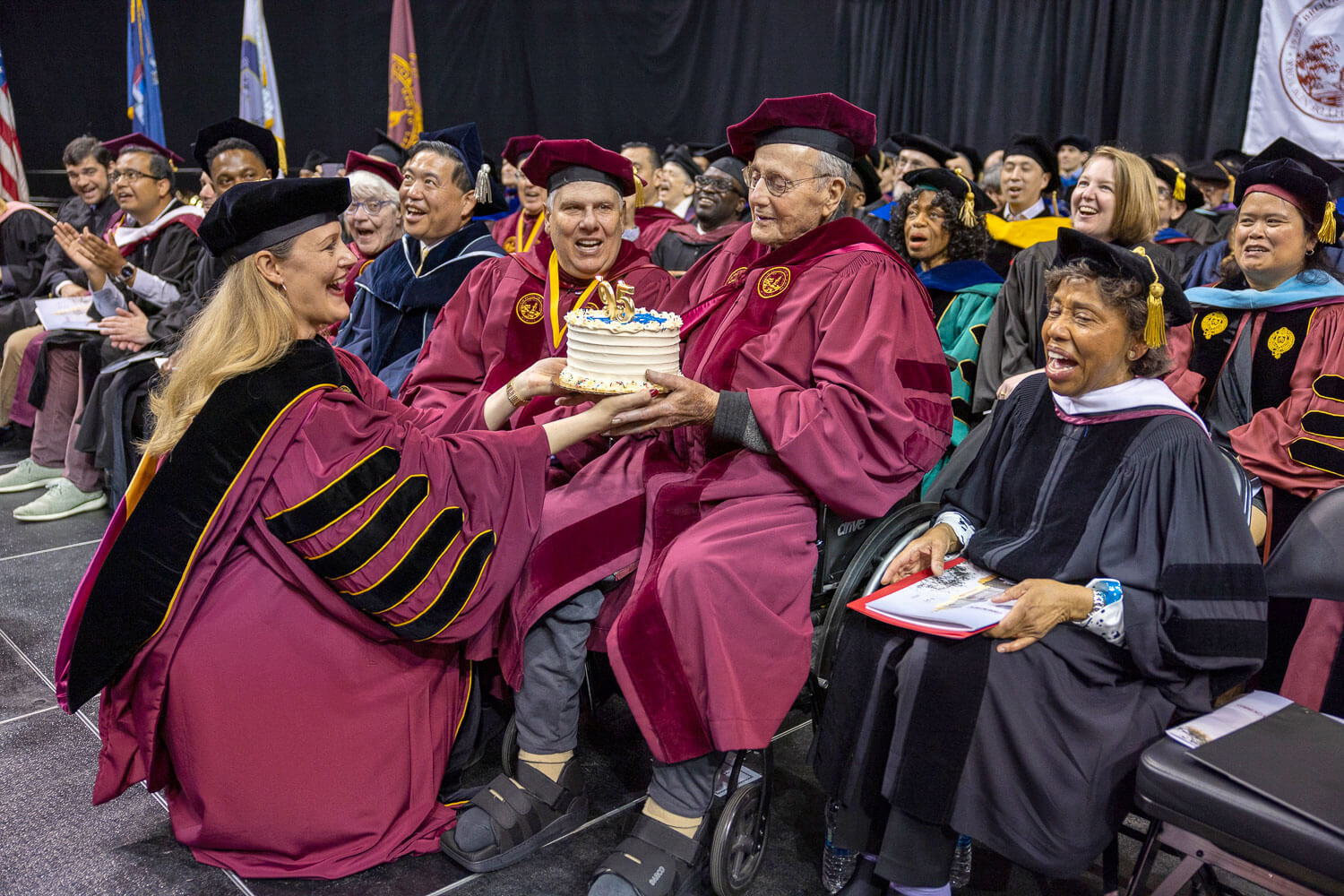 President Michelle J. Anderson presents Leonard Tow ’50 with a birthday cake.