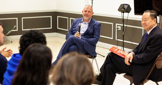 Aon EVP Aaron Olson and Dean Qing Hu discuss the insurance industry in front of an audience of students and faculty on September 22. Olson is the latest Executive-In-Residence at the Murray Koppelman School of Business.